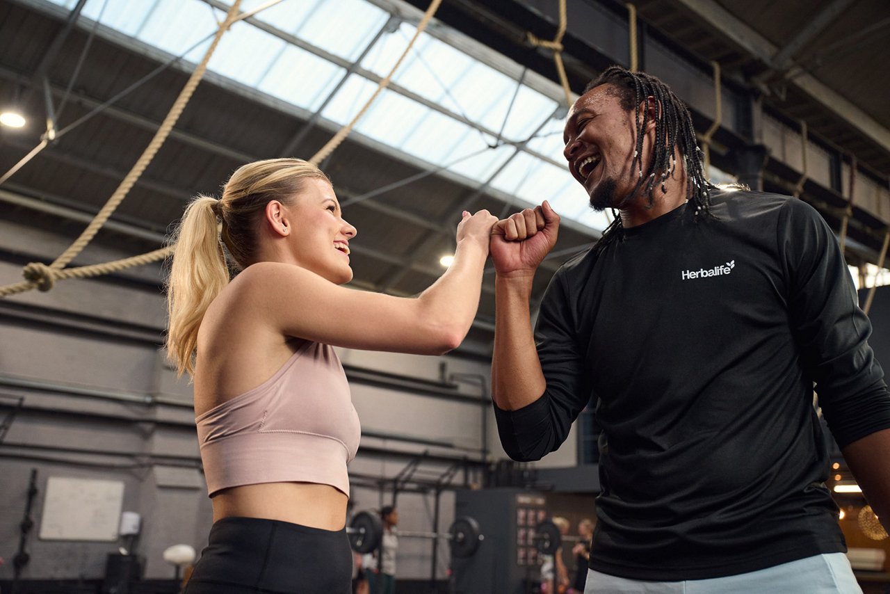 Distributor leading a fitness workout of people outdoors